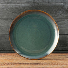 Ceramic dinner plate with teal glazed center and orange ring edge