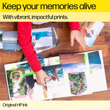 Original ink promo banner with hands arranging photo prints on a wooden table