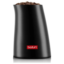 Electric coffee grinder in black with coffee beans visible in transparent top