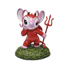 Pink alien figure in a red devil costume holding a trident on a green base