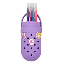 Purple silicone charm pencil case holding colored pencils, with bunny and heart details