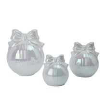 Three silver-toned glass bow ornaments with ribbed fronts