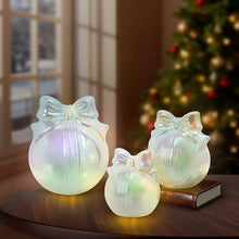 Three iridescent glass bow ornaments in graduated sizes