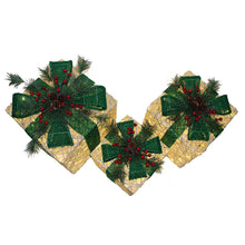 Three gold lighted gift boxes with green bows and pine clusters on top