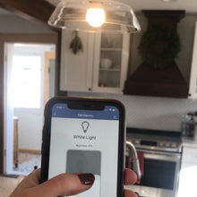 Smartphone displaying smart bulb control screen with hand holding device