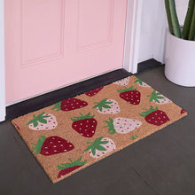 Coir outdoor mat with strawberry pattern, tan with red and pink fruit icons.