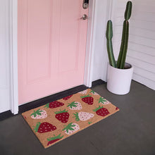 Coir outdoor mat with strawberry pattern on entry floor, tan with red and pink icons.