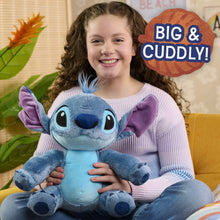 Blue plush alien character with purple ears, antenna tuft, and cuddly fuzzy legs.