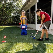 Kids playing with blue rolling toy golf set, clubs, balls, and numbered tees on grass