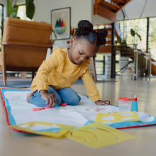 Door-and-floor doodle mat on the floor, white with colorful areas for drawing
