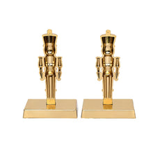 Back view of two gold nutcracker stocking holders with rectangular bases