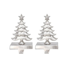 Pair of silver Christmas tree stocking holders with star toppers and mantle hooks