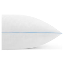 White bed pillow with blue piping seam, close-up edge profile