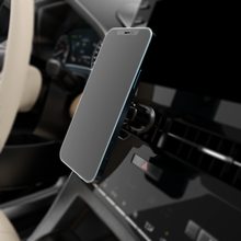 Smartphone mounted on magnetic air-vent holder clip, showing blue edge