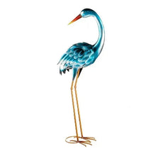 Heron metal statue with teal body, orange beak, and gold wire legs with ring base.