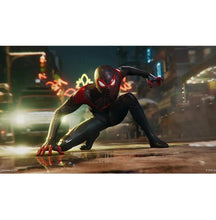 Spider-Man Miles Morales action artwork crouching on street with glowing city lights