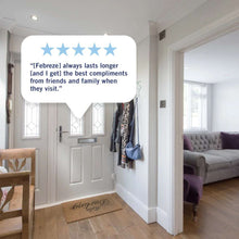 White Febreze plug-in air freshener oil refill plugged into a wall outlet