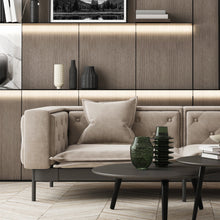 Indoor LED strip accent lighting behind sofa emitting warm white light