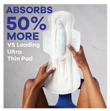Overnight maxi pads with wings, ultra thin pad shown in hands