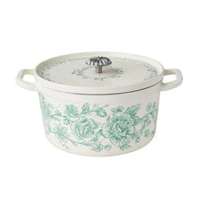 Green floral enameled cast iron Dutch oven with domed lid and loop side handles