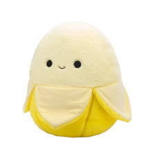 Yellow banana plush toy with round fuzzy top, smiling face, white belly panel