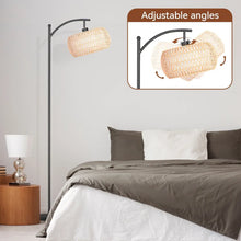 Black arc floor lamp with woven rattan drum shade and adjustable head