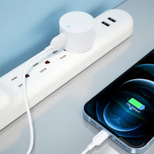 White USB-A wall charger with foldable plug and attached Lightning cable