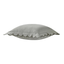 Sage green square decorative pillow with scalloped flange trim, angled view