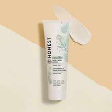 Baby face and body lotion tube with a dollop of white cream on the side
