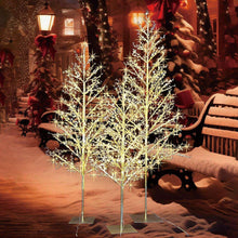 Warm white LED beaded trees with twinkling lights on metal bases in snowy yard