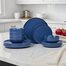 Blue stoneware dinnerware set with stacked plates and bowls on table
