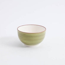 Green and beige ceramic dinner bowl with red rim and concentric ring texture