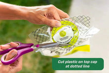 Fly trap kit: white mesh bag with green cap and inner funnel, held in hands