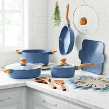 Blue cast aluminum cookware set with lids, wooden handles, and spatula tools