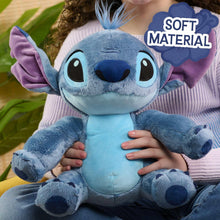 Blue plush alien character with purple ears, fuzzy arms, and a stitched belly panel.