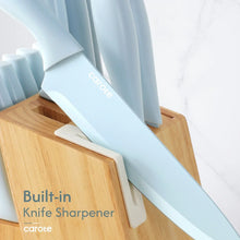 Ceramic knife sharpening in built-in sharpener slot with light blue blade