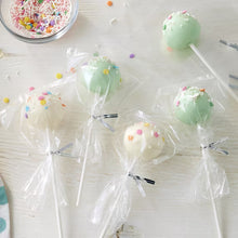 Clear cake pop treat bags with silver ties holding cake pops on lollipop sticks