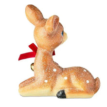 Sitting deer tabletop decoration from side, brown glitter with red ribbon bow and bell