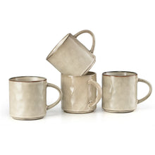 Four ceramic coffee mugs in light beige with curved handles and wave texture