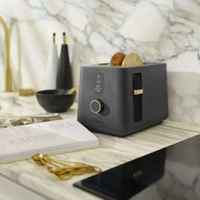 Slate grey toaster on marble countertop with control dial and side lever visible