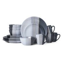 Gray stoneware dinnerware set with stacked plates, bowls, and handled mugs