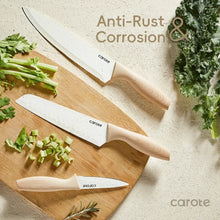 Ceramic kitchen knives with cream handles on a wooden board with chopped vegetables