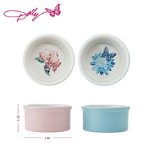Two round ceramic ramekins with pink and blue exteriors and floral interior decals.