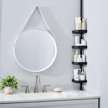 Corner shower caddy with four matte black shelves holding toiletries on bathroom wall