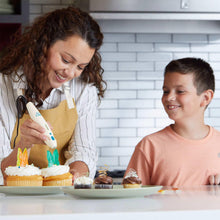 3Doodler Chef 3D pen creating designs on cupcakes, white body with blue dots