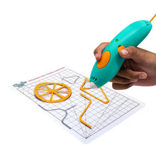 Teal 3D pen in hand creating an orange design on a gridded pad