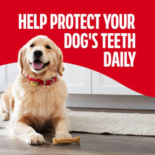 Milk-Bone brushing chew bone on the floor with a golden retriever nearby