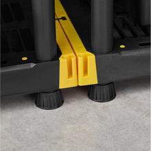 Yellow connector block and black adjustable feet for shelf frame