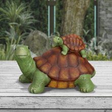 Garden turtle figurine with baby turtle on back, green legs and orange-brown textured shell