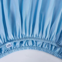 Light blue fitted bed sheet with elastic edge and gathered skirt detail